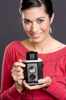 Pretty woman with vintage camera