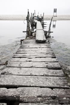 Desolated wooden pier in low saturation