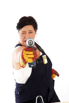 Playful woman taking aim with power drill 