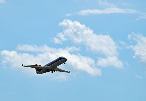 A Commercial Airliner Taking Off into a Partly Cloudy Blue Sky