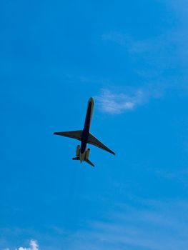 A Commercial Airliner Taking Off into a Partly Cloudy Blue Sky