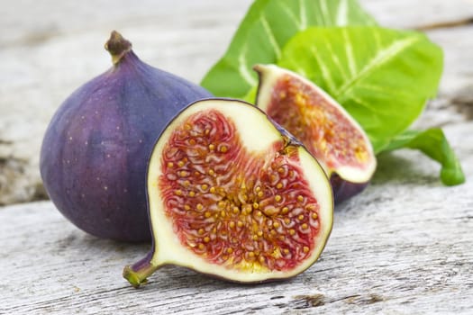 Fresh figs on old wooden background