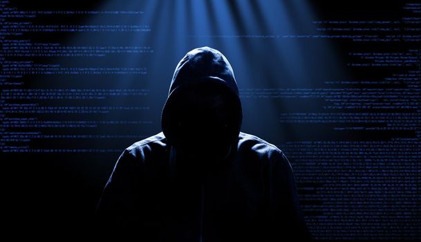 Anonymous internet hacker in front of computer. Web crime concept