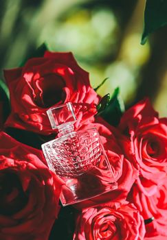 Perfume and bouquet of red roses, perfumery as luxury gift, beauty flatlay background and cosmetic product ad