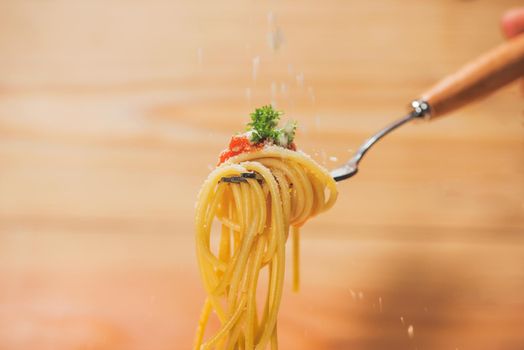 Close-up of asta spaghetti with tomato sauce, olives and garnish. Italian food. 