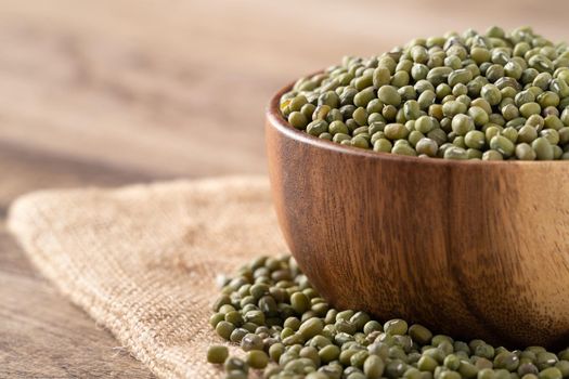 Close up of raw mung bean on wooden table background.