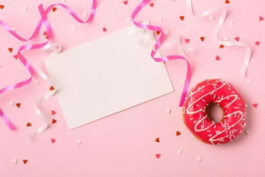 Donuts with icing on pastel pink background with copyspace. Sweet donuts.