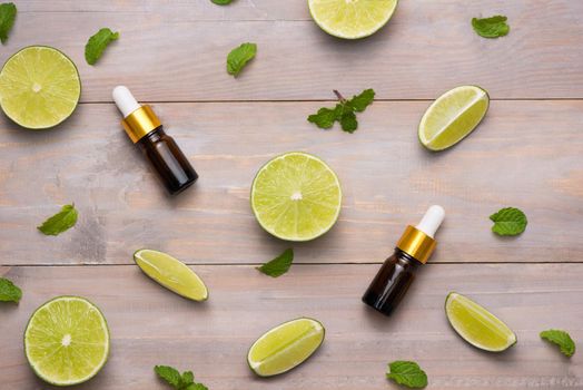 Natural cosmetics for home spa. Bottle of essence oil with fresh limes 