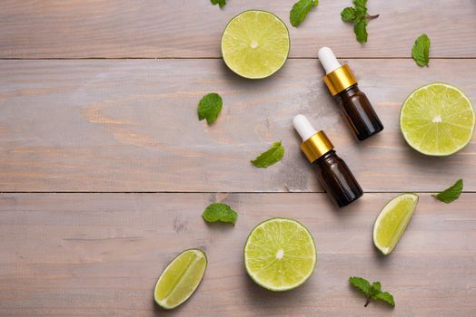 Natural cosmetics for home spa. Bottle of essence oil with fresh limes 