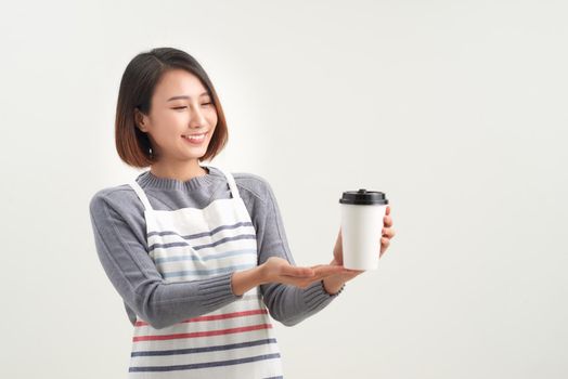 Coffee cup to go being held out by a barista, waiter, or professional