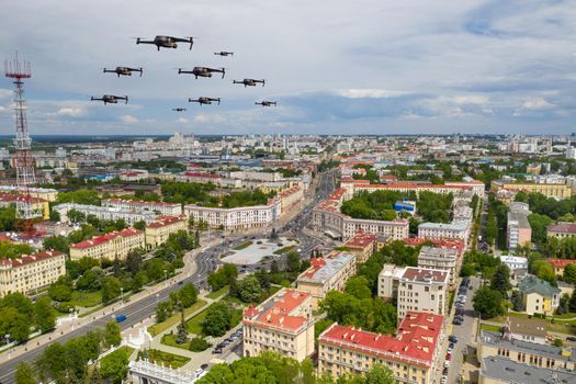 Drones fly over a residential city. Urban landscape with drones flying over it, quadrocopters