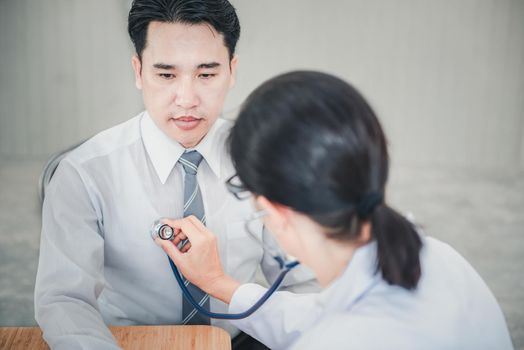 Medical Doctor is Examining Patient Health With Stethoscope in Hospital Examination Room, Female Physician Doctor is Diagnosing Physical Health Check Up for Male Patient. Medicine/Healthcare Concept