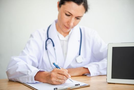 Medical Doctor is Working in Hospital Examination Room, Female Physician Doctor is Diagnosing Physical Health Check Up and Consulting for Patients at Examining Desk Medicine/Healthcare Concept