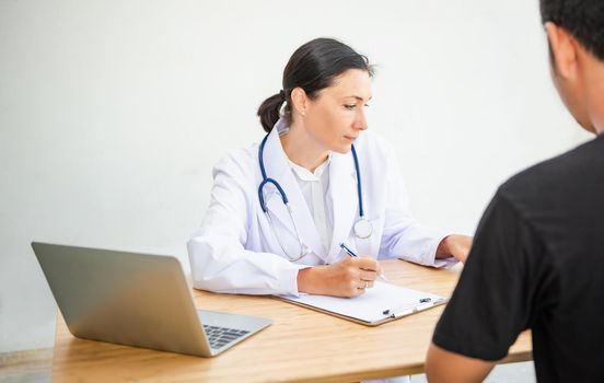 Medical Doctor is Working in Hospital Examination Room, Female Physician Doctor is Diagnosing Physical Health Check Up for Patients. Medicine/Healthcare Concept