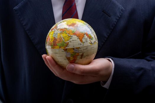 Man holding an earth globe model in his hands