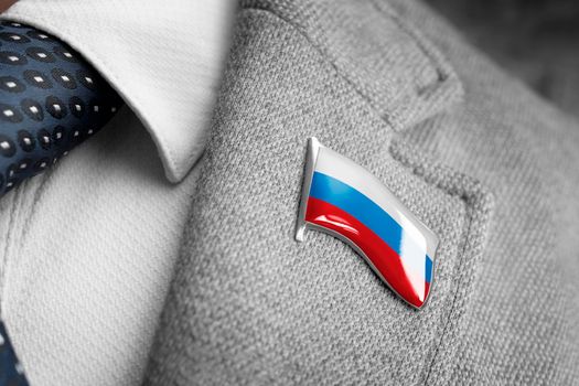 Metal badge with the flag of Russia on a suit lapel