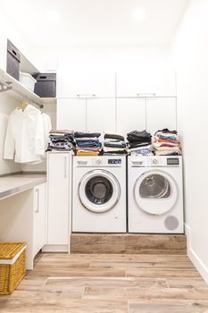 Stacks of clean clothes in utility room