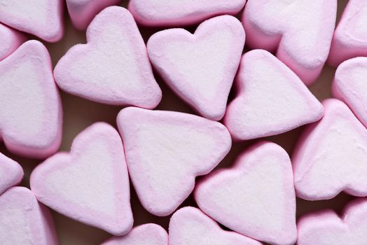 Valentines Day candy hearts marshmallows over green background