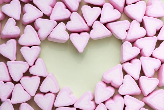 Valentines Day candy hearts marshmallows over green background