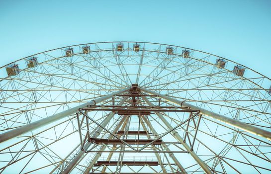 silhouette of Ferris wheel on the background of blue sky