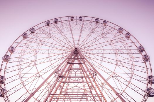 silhouette of Ferris wheel on the background of blue sky