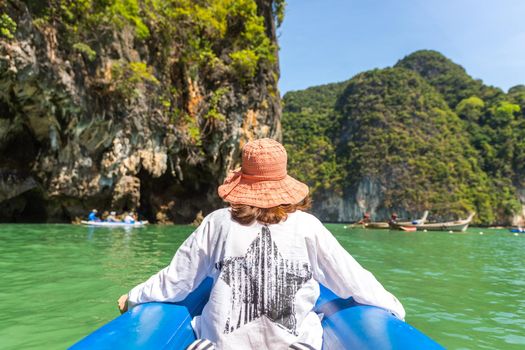 Waman wearing hat sailing in boat in Thailand