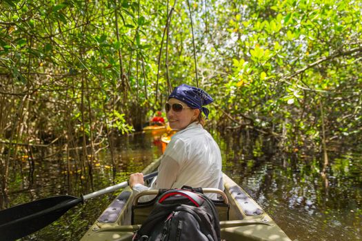 Tourist kayaking in mangrove forest in Everglades Florida, USA