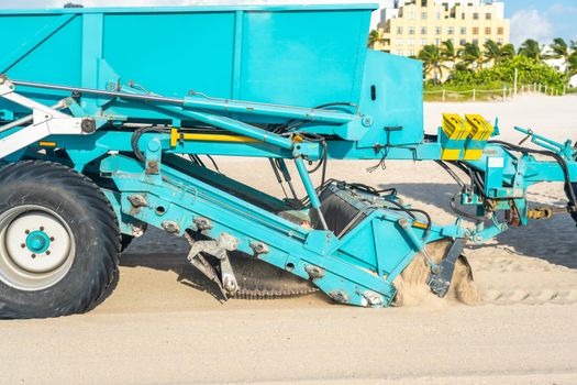 Tractor cleaning sand in South beach in Miami