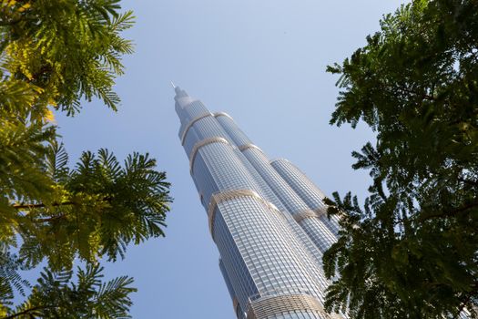 DUBAI, UNITED ARAB EMIRATES – JANUARY 20: Tower Burj Khalifa vanishing in blue sky on January 20, 2014 in Dubai. It is the tallest structure in world since 2010, 829.8 meters and one of the most visited tourist attractions in the world.