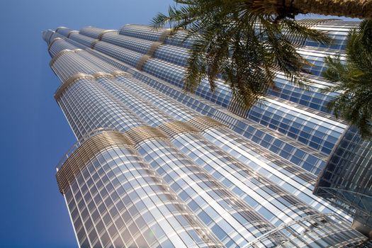 DUBAI, UNITED ARAB EMIRATES – JANUARY 20: Tower Burj Khalifa vanishing in blue sky on January 20, 2014 in Dubai. It is the tallest structure in world since 2010, 829.8 meters and one of the most visited tourist attractions in the world.