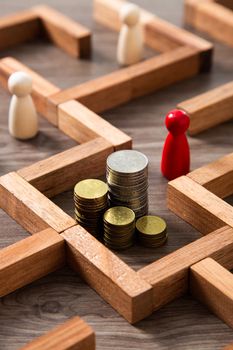 Group of coins heaps in the maze game built by wood blocks, find a way to money resource concept