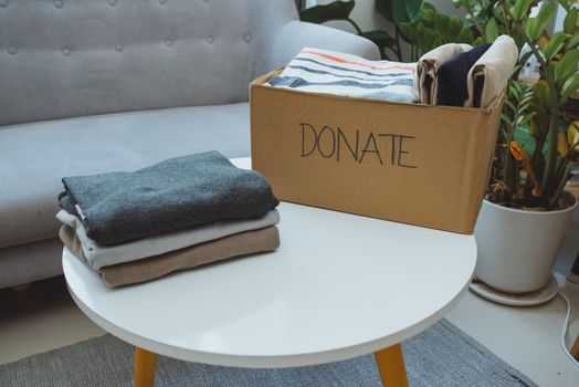 Donation box and casual clothes in livingroom