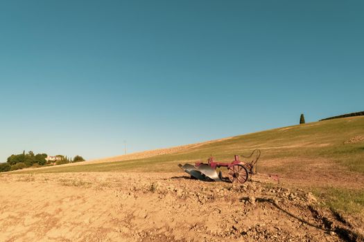 Closeup of a plow standing on a hill in the idyllic Tuscan countryside