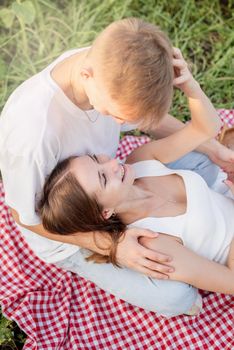 Young couple cuddling on a picnic blanket
