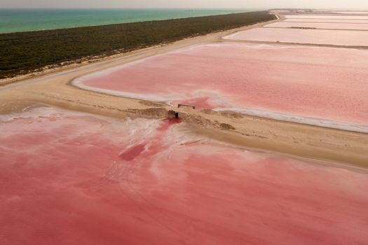 Aerial view of the pink salt lakes separated by a sand spit from the Gulf of Mexico on the Yucatan in Mexico
