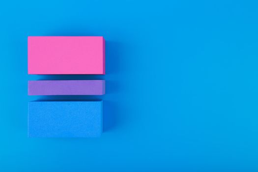 Minimal composition with bisexual pride flag against blue background with copy space