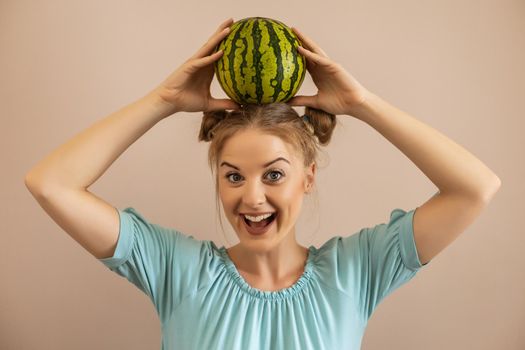 Woman holding  watermelon on her head