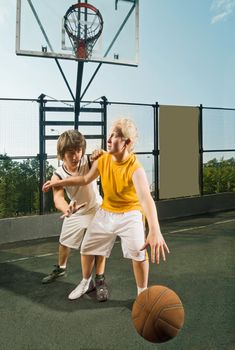 Two teenage players with basketball