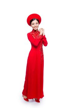 Young vietnamese woman in Ao Dai Dress with praying gesture wishing you good luck