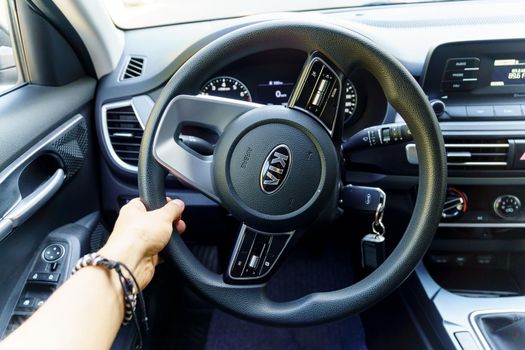 Tyumen, Russia-September 04, 2021: Steering wheel in a car interior, close up. Vehicle interior. Kia company