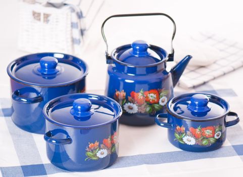 Kitchen utensil set of blue pots and kettle
