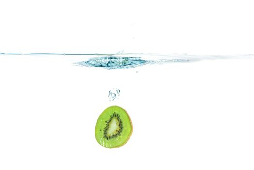 Sliced kiwi fruit splashing isolated on white background