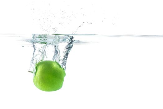 Water splash. Green apple under water. Air bubble and transparent water