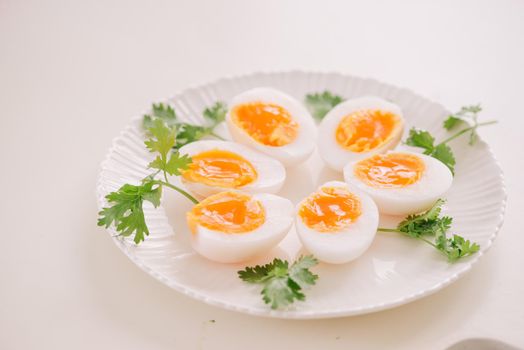 Close up medium soft boiled duck egg portion on white dish