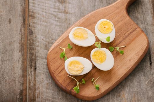 Boiled eggs on cutting board. Selective focus, space for text