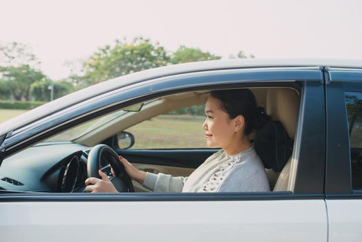 Happy Asian woman driving travel by herself.