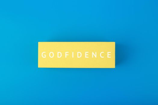 Godfidence single word against bright blue background. Religious and faith concept