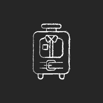 Open suitcase with clothing chalk white icon on dark background