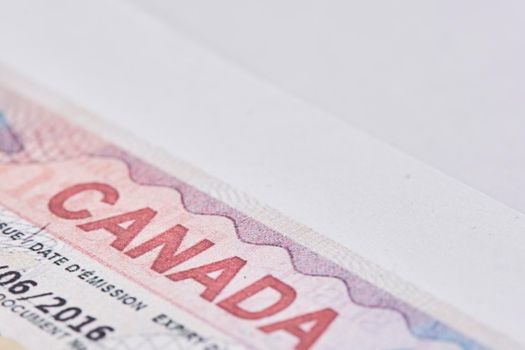 Canadian visa in passport. Close-up view