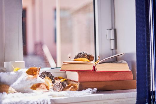 Bright autumn background with books and coffee mug